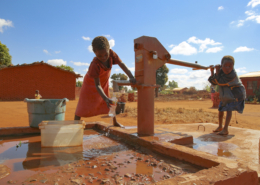 CBCC- a child pumps water at the village well