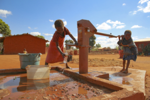 CBCC- a child pumps water at the village well