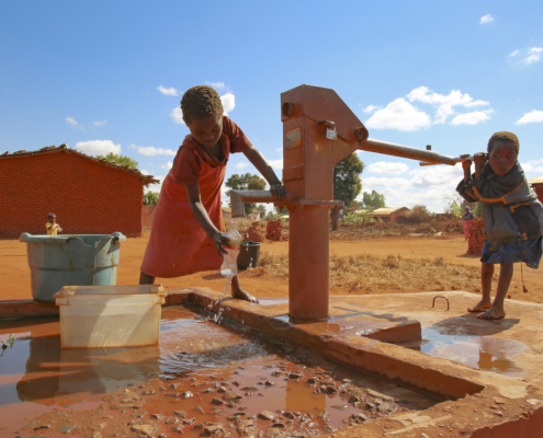 CBCC- a child pumps water at the village well