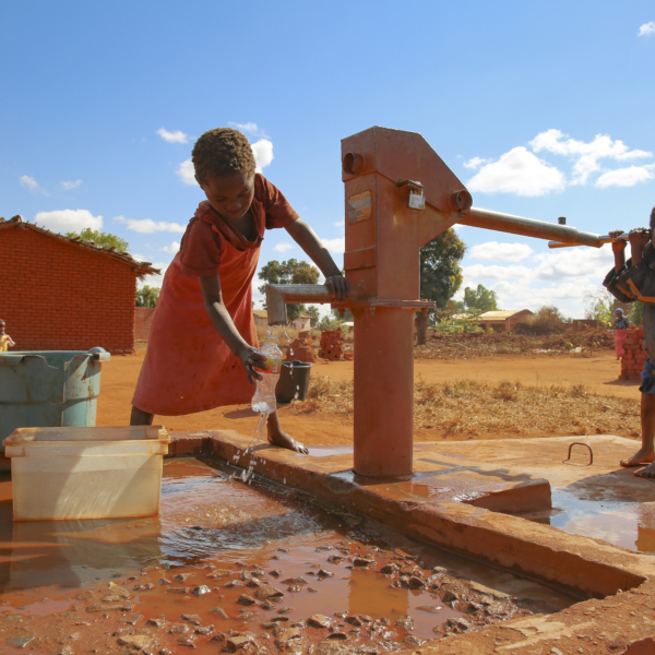 CBCC- a child pumps water at the village well